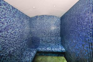 - une douche carrelée de bleu avec un banc dans la chambre dans l'établissement Laren Sea Side Hotel Spa, à Antalya 16 autres photos