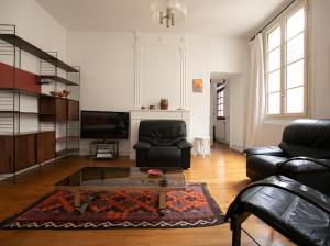 a living room with a couch and a coffee table at La luciole in Périgueux