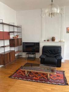 a living room with a couch and a glass coffee table at La luciole in Périgueux