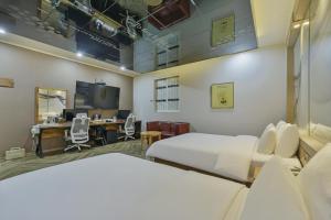 a hospital room with two beds and a desk at Palace Hotel in Ulsan