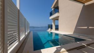 een huis met een zwembad naast een gebouw bij Villa Sole Komarna by Villas Guide in Klek