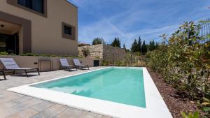 a swimming pool in the backyard of a house at Villa D Cube by Villas Guide in Duba