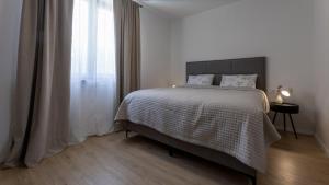 a bedroom with a bed and a window at Villa D Cube by Villas Guide in Duba +21 photos