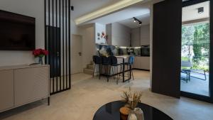 a kitchen and living room with a table and chairs at Villa D Cube by Villas Guide in Duba
