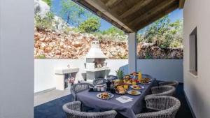 a table with food on it on a patio at Villa Bohemia by Villas Guide in Dubrovnik