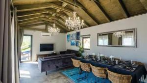 a dining room with a long table and chairs at Villa Bohemia by Villas Guide in Dubrovnik