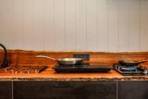 a kitchen counter with two pans on a stove at Galbraith Beach Studio 1 - steps away from beach in Marengo +6 photos