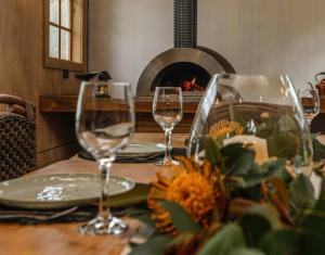 a table with two wine glasses on a table with a fireplace at Galbraith Beach Studio 1 - steps away from beach in Marengo