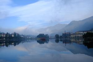 a view of a lake with buildings and mountains at Hotel Sao Xanh in Sapa