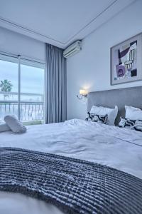 a bedroom with a large bed with a view of the ocean at Spacious 3BR 174m2 Quiet Residential Casablanca in Casablanca