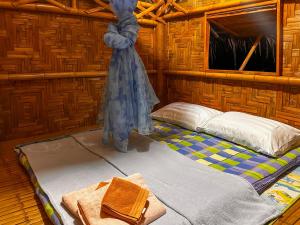 a small room with a bed and a window at Baan Panmala Homestay - Ao Luek, Krabi in Krabi