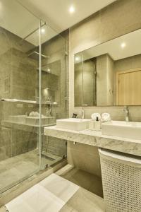 a bathroom with two sinks and a glass shower at Spacious 3BR 174m2 Quiet Residential Casablanca in Casablanca +62 photos