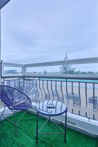 two chairs and a table on a balcony at Spacious 3BR 174m2 Quiet Residential Casablanca in Casablanca
