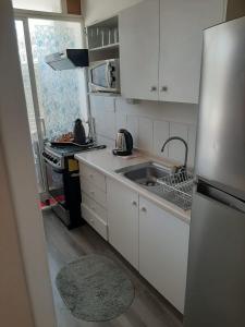 a kitchen with a sink and a refrigerator at Galicia in La Serena