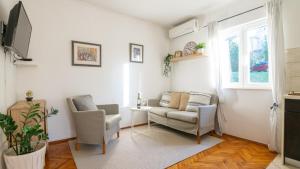 a living room with a couch and two chairs at House Rilovic by Villas Guide in Srednji Radovčići