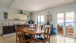 a kitchen and dining room with a table and chairs at Grand view Orasac by Villas Guide in Dubrovnik