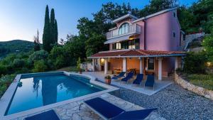 a house with a swimming pool in front of it at Grand view Orasac by Villas Guide in Dubrovnik