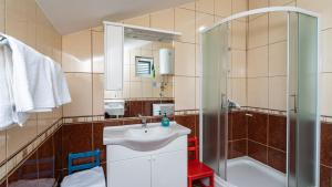 a bathroom with a sink and a shower at Grand view Orasac by Villas Guide in Dubrovnik +27 photos