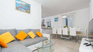 a living room with a couch and a dining room at Cypress Paradise by Villas Guide in Dubravka