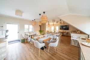 a dining room with tables and chairs in a room at Haus Lindolino in Elsterheide