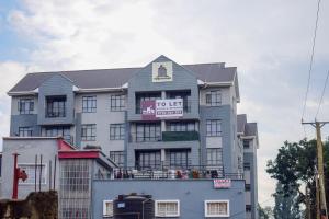 a building with a sign on the top of it at Stayride Homes in Ruaka +3 photos