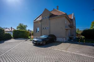 a car parked in front of a house at B&B Lajta Park in Mosonmagyaróvár