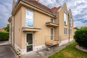 a house with a balcony on the side of it at B&B Lajta Park in Mosonmagyaróvár