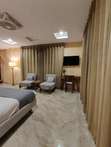 a hotel room with a bed and a desk at Hotel Demanchi Kalam in Kārandūkai