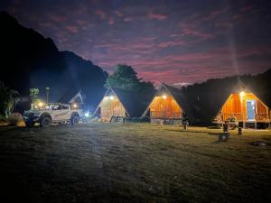 a truck parked in front of some tents at night at Phoutthasack Guesthouse in Nongkhiaw