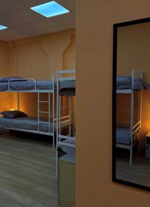 a mirror in a room with bunk beds at Трініті Хаус in Kyiv +16 photos