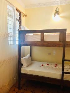 Postel nebo postele na pokoji v ubytování Rafiki Zanzibar Residence