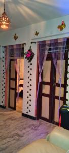 a room with two doors with purple drapes at Le Green House Villa in Pondicherry