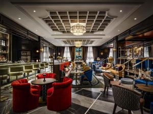 a lobby with tables and chairs and a bar at Fairmont Royal York Hotel in Toronto