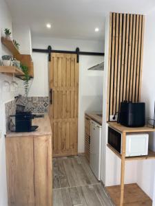 a small kitchen with wooden doors and a counter at casa kayla in Palm-Mar
