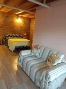 a living room with a couch and a bed at Cabañas San Valentin in Lago Puelo