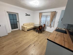 a living room with a table and a couch at Casa Romanța in Cehu Silvaniei +4 photos