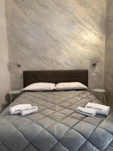 a bedroom with a bed with two pillows on it at Dimora Lanamar in Conversano