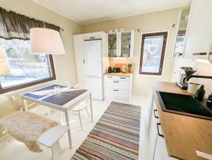 a kitchen with a table and a sink in it at A little home in Lahti
