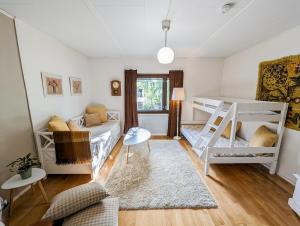 a bedroom with two bunk beds and a couch at A little home in Lahti