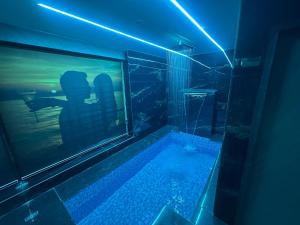 a man taking a picture of himself in a tub in a room at Hotel THE Vibes in Koba
