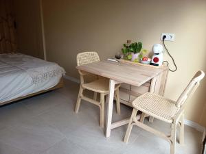 a table and two chairs in a room with a bed at La única in Coín +18 photos