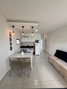 a kitchen and living room with a table and a couch at Pôr do Sol - Serraruna in Araruna