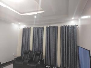a room with a bunch of curtains in a room at Mwisenix apartment in Kigali