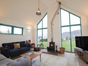 a living room with a couch and a fireplace at Sonas in Strathcarron