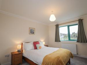 a bedroom with a bed and a window at Sonas in Strathcarron