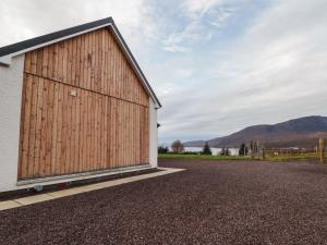 a barn with a large door on the side of a building at Sonas in Strathcarron