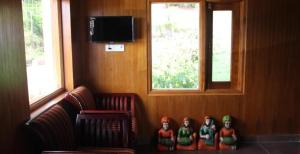 a living room with a group of figurines in front of a window at Golden Springs in Ooty