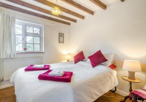 a bedroom with a large white bed with purple towels on it at 3 Bed in Awre oc-s34503 in Awre