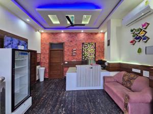 a living room with a couch and a tv at Hotel The SOHO in Chandīgarh