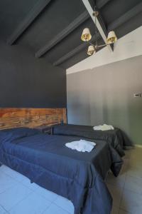 En eller flere senge i et værelse på AUREA HOTELES - Villa Carlos Paz